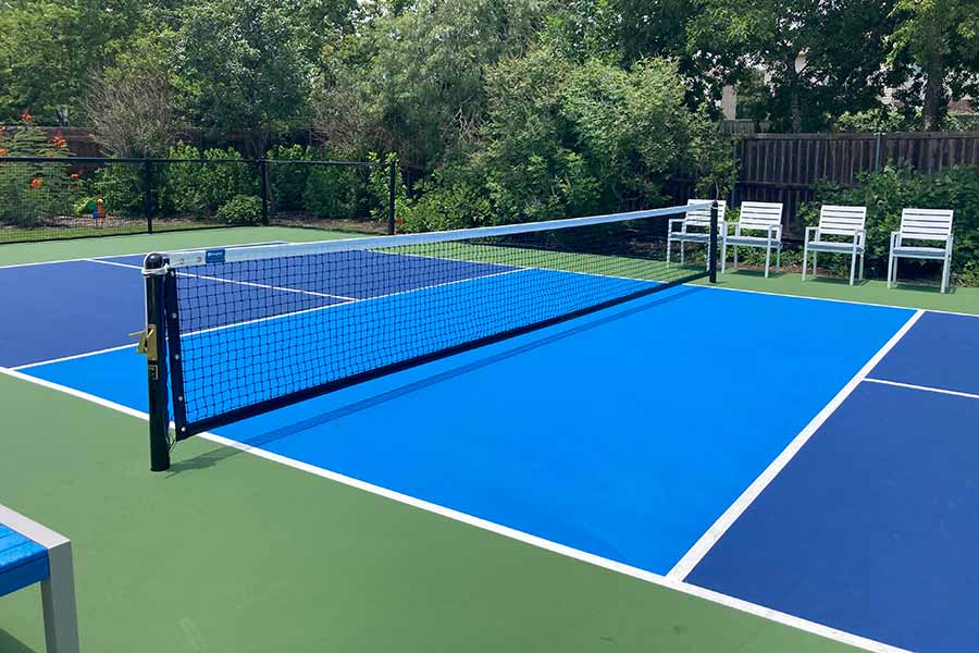 Outdoor pickleball court with net and painted lines